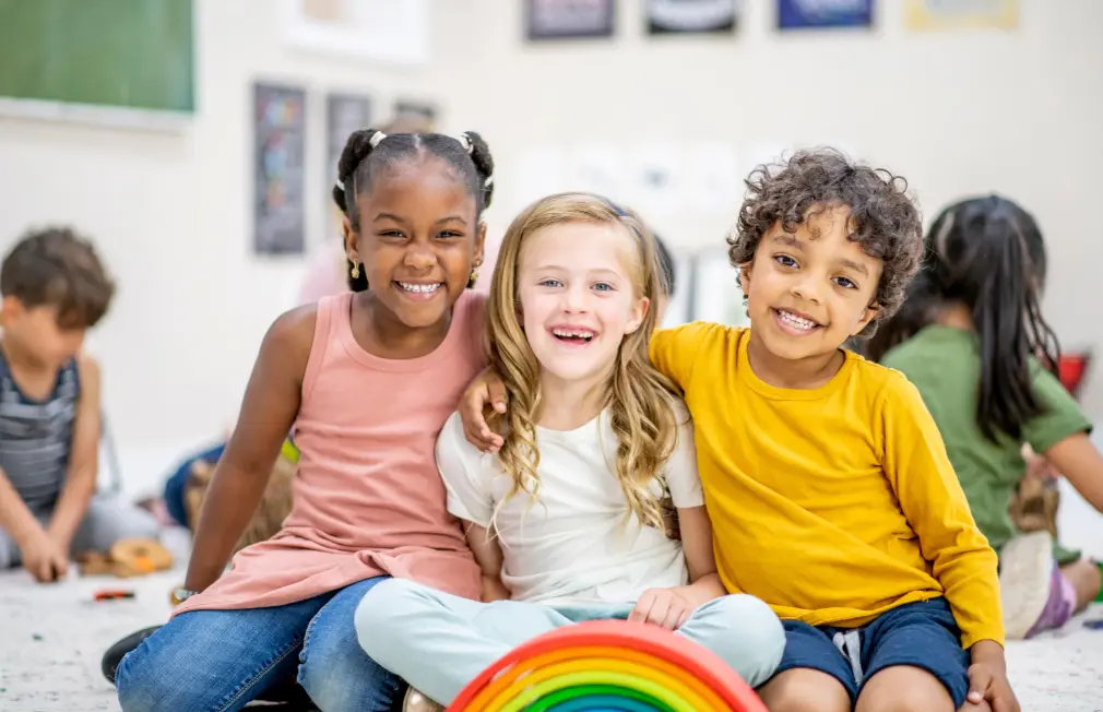 A diverse group of kids smiling together.